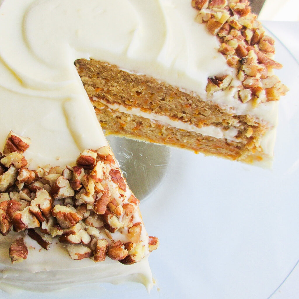 Amaretto carrot cake with a slice taken.