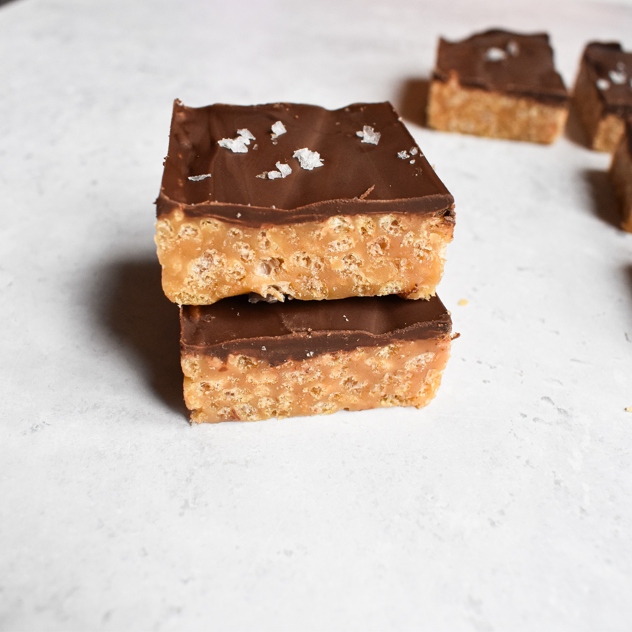 Caramel rice krispie squares stacked.